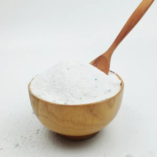 Laundry powder in a wooden bowl with a wooden scoop