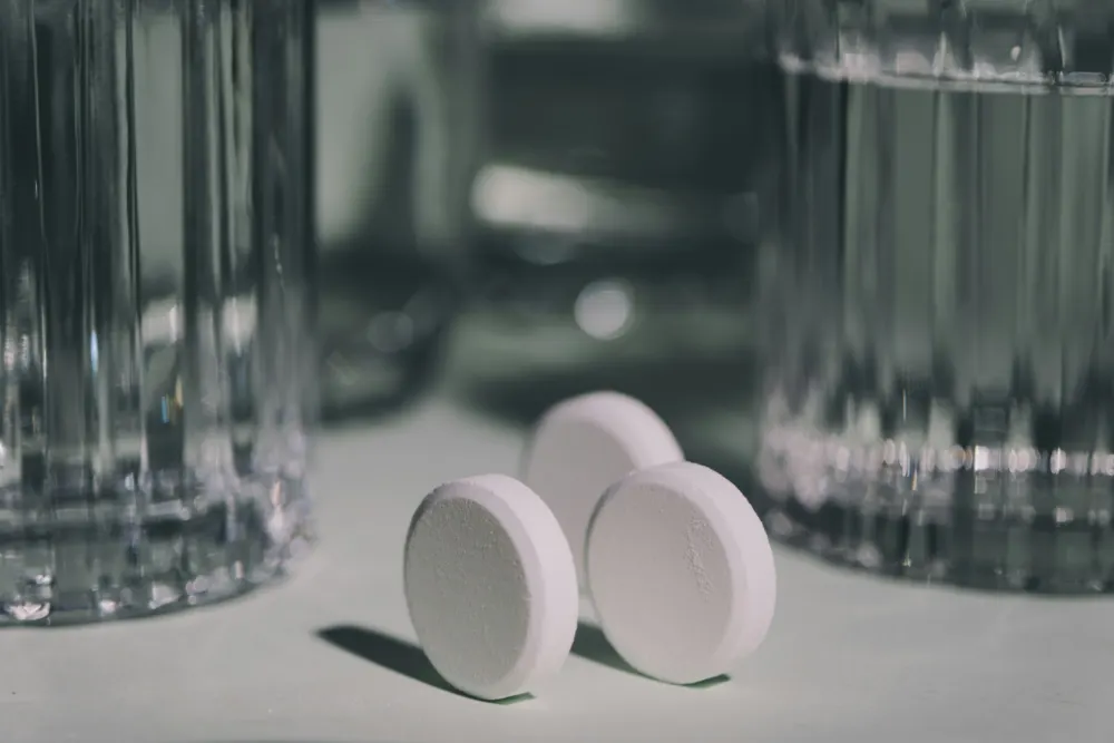 Cleaning tablet dissolving in a glass of water