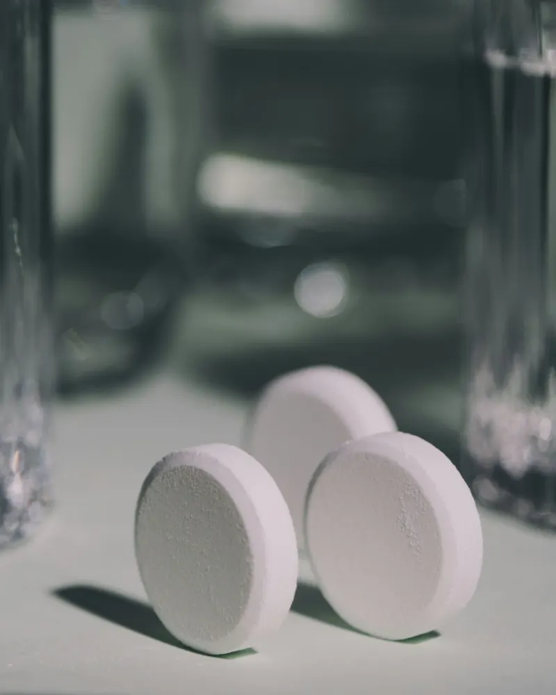Cleaning tablet dissolving in a glass of water